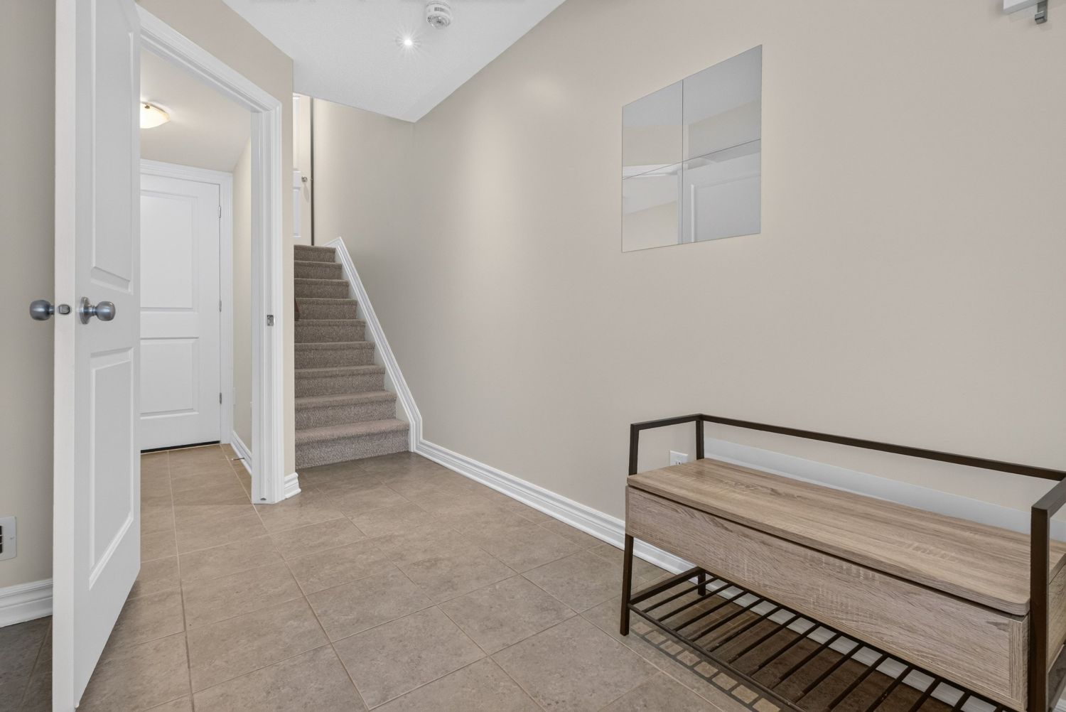 Tiled foyer with bench and stairs