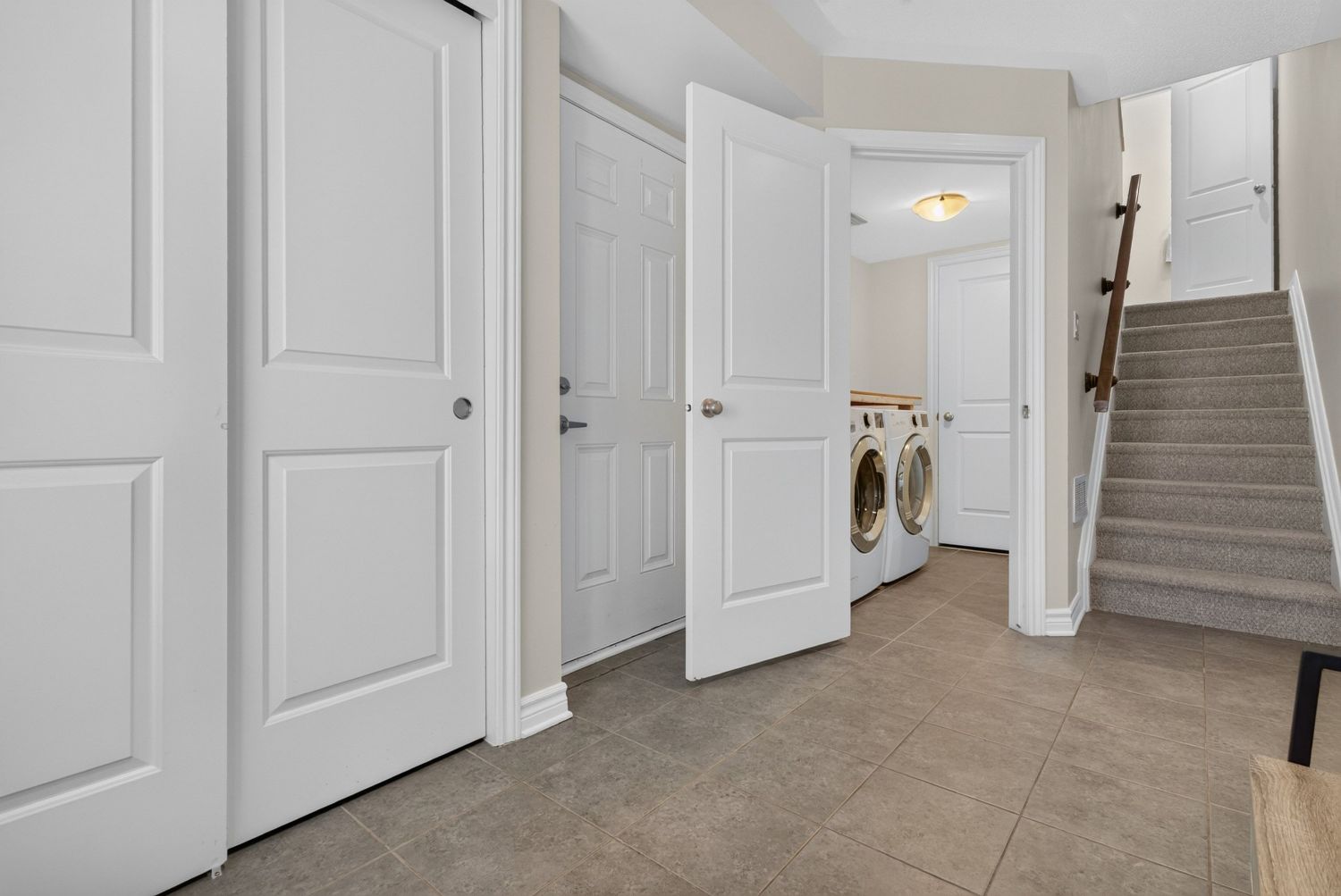 Entry hall with laundry room and understair storage