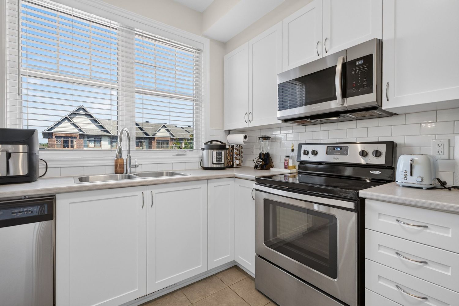 Kitchen with stainless appliances and subway tile