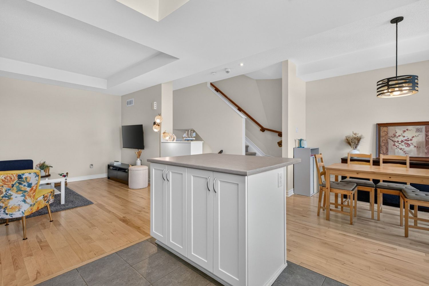 Open concept living, kitchen island and dining