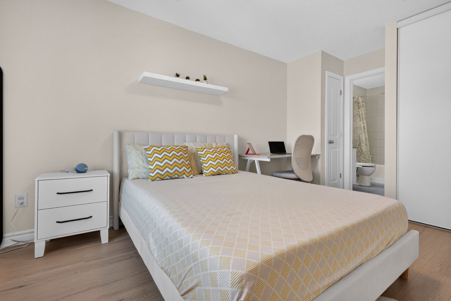 Primary bedroom with ensuite beyond